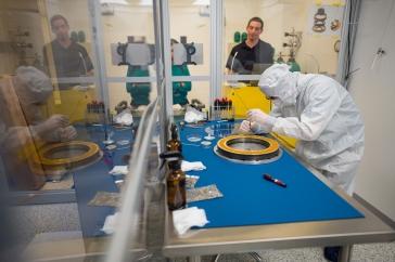 Scientist in a "bunny suit" works on a NASA project in a clean room